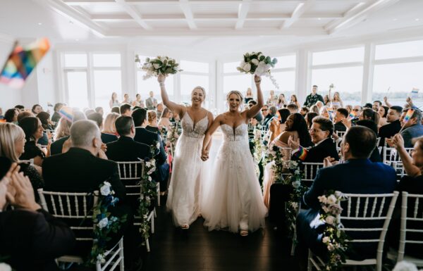 A Waterfront Wedding Featuring The Couple’s Dog & Pride Flags at the Ceremony