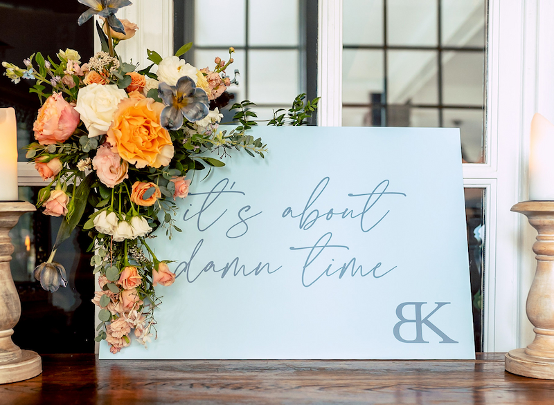 For their Ryland Inn wedding, the couple wanted a funny sign to make people laugh. This one reads It's About Damn Time.