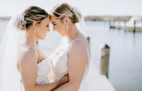 A Waterfront Wedding Featuring The Couple’s Dog & Pride Flags at the Ceremony