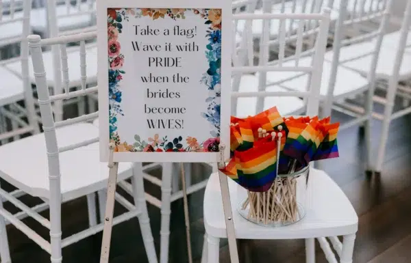 A Waterfront Wedding Featuring The Couple’s Dog & Pride Flags at the Ceremony