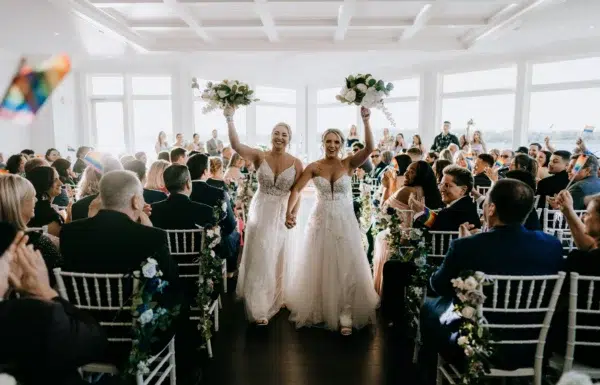 The wedding of A Waterfront Wedding Featuring The Couple’s Dog & Pride Flags at the Ceremony Gallery 0