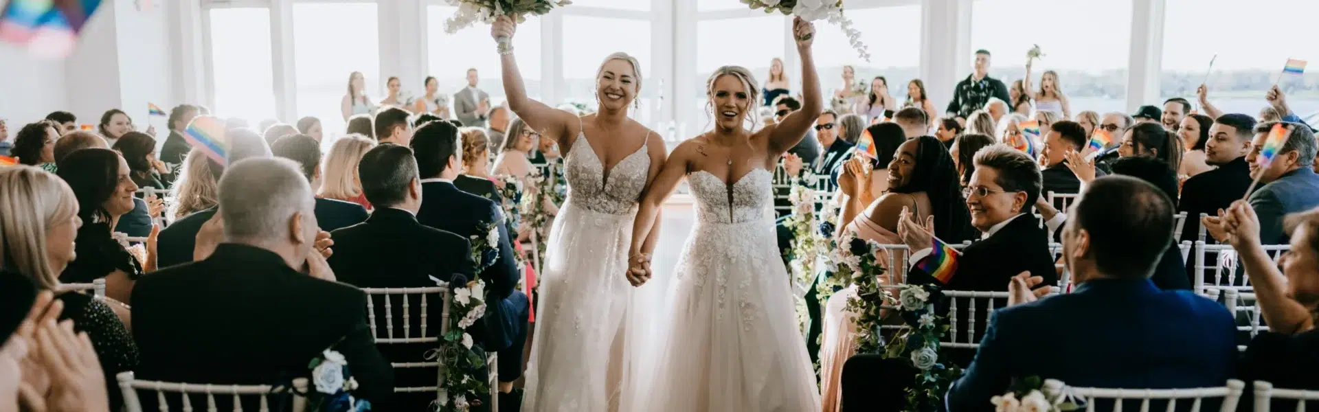A Waterfront Wedding Featuring The Couple’s Dog & Pride Flags at the Ceremony
