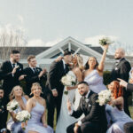 A Coastal Elegant Lavender Wedding With Custom Trucker Hats, & Their Dog on the Drink Toppers at Crystal Point Yacht Club