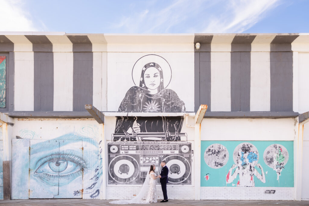 Bride and groom on Asbury Park boardwalk before restaurant wedding ceremony
