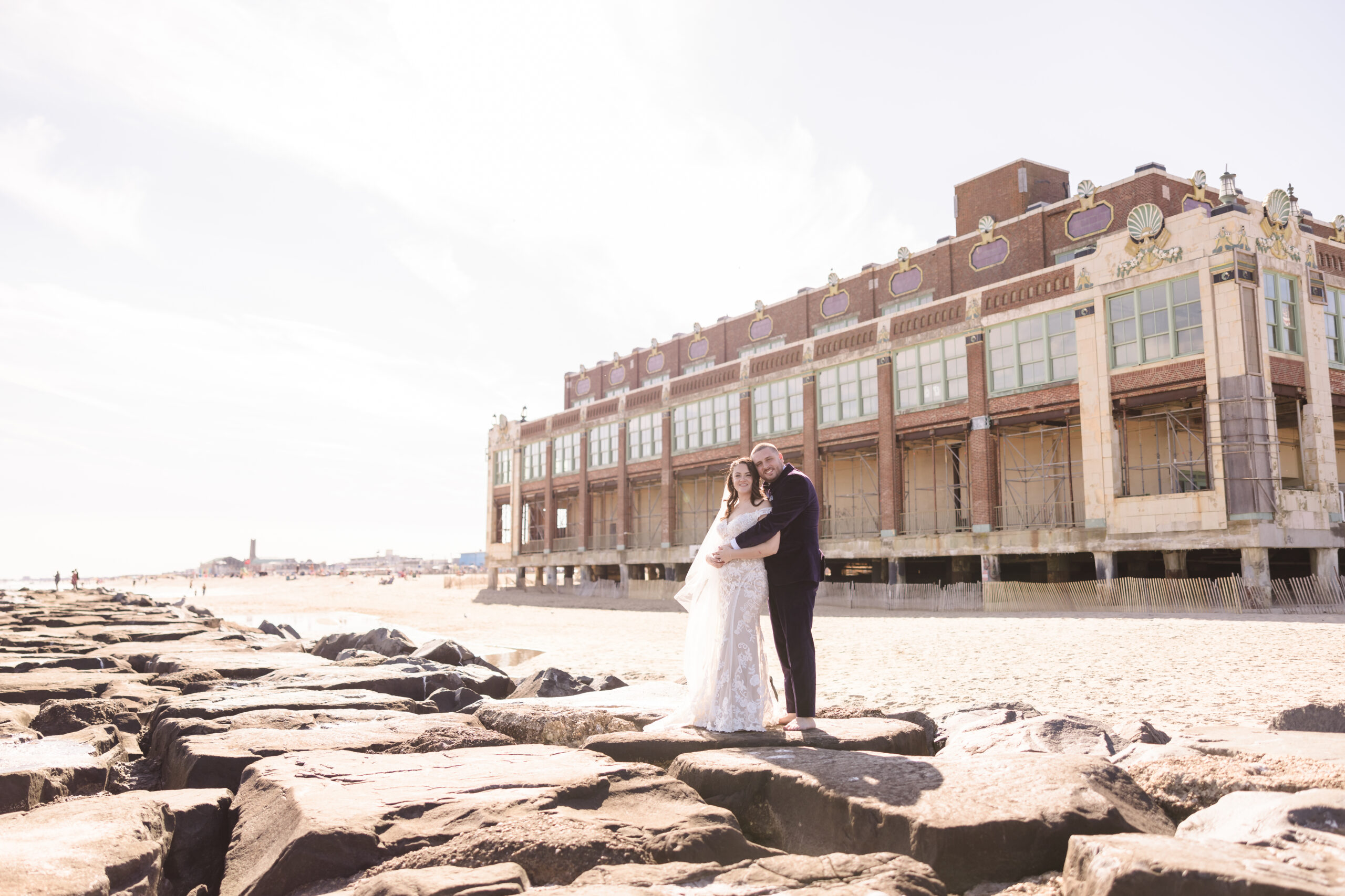 Bride and groom on Asbury Park boardwalk before restaurant wedding ceremony