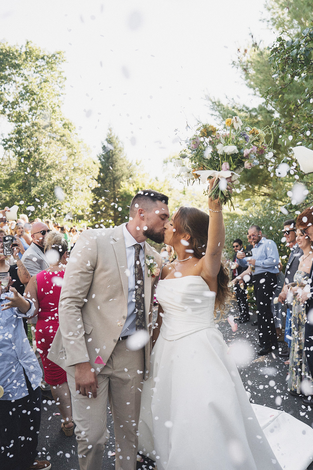Bride surrounded by bulk DIY flower stems at a New Jersey backyard wedding