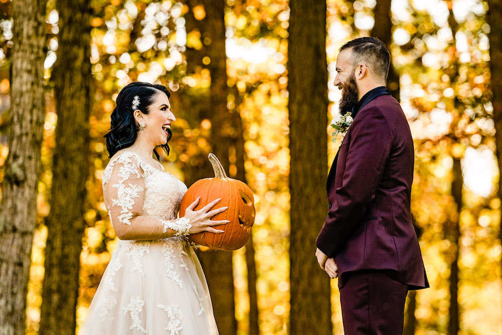 amanda-greg-blue-heron-pines. nj halloween wedding laughing goth bride first look with pumpkin groom turns around