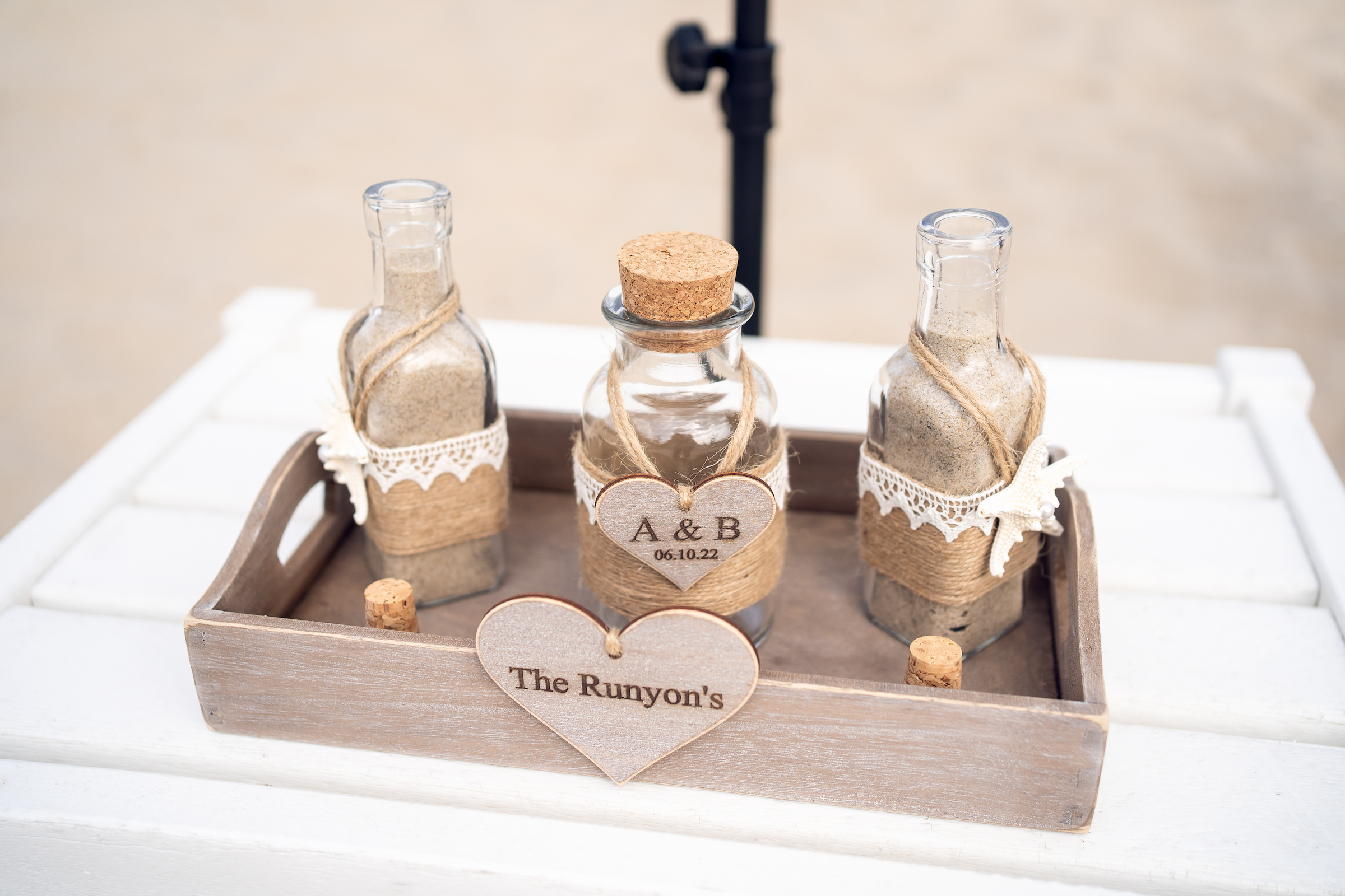 Sand in three bottles for the couple's Sea Shell Resort and Beach Club wedding ceremony.