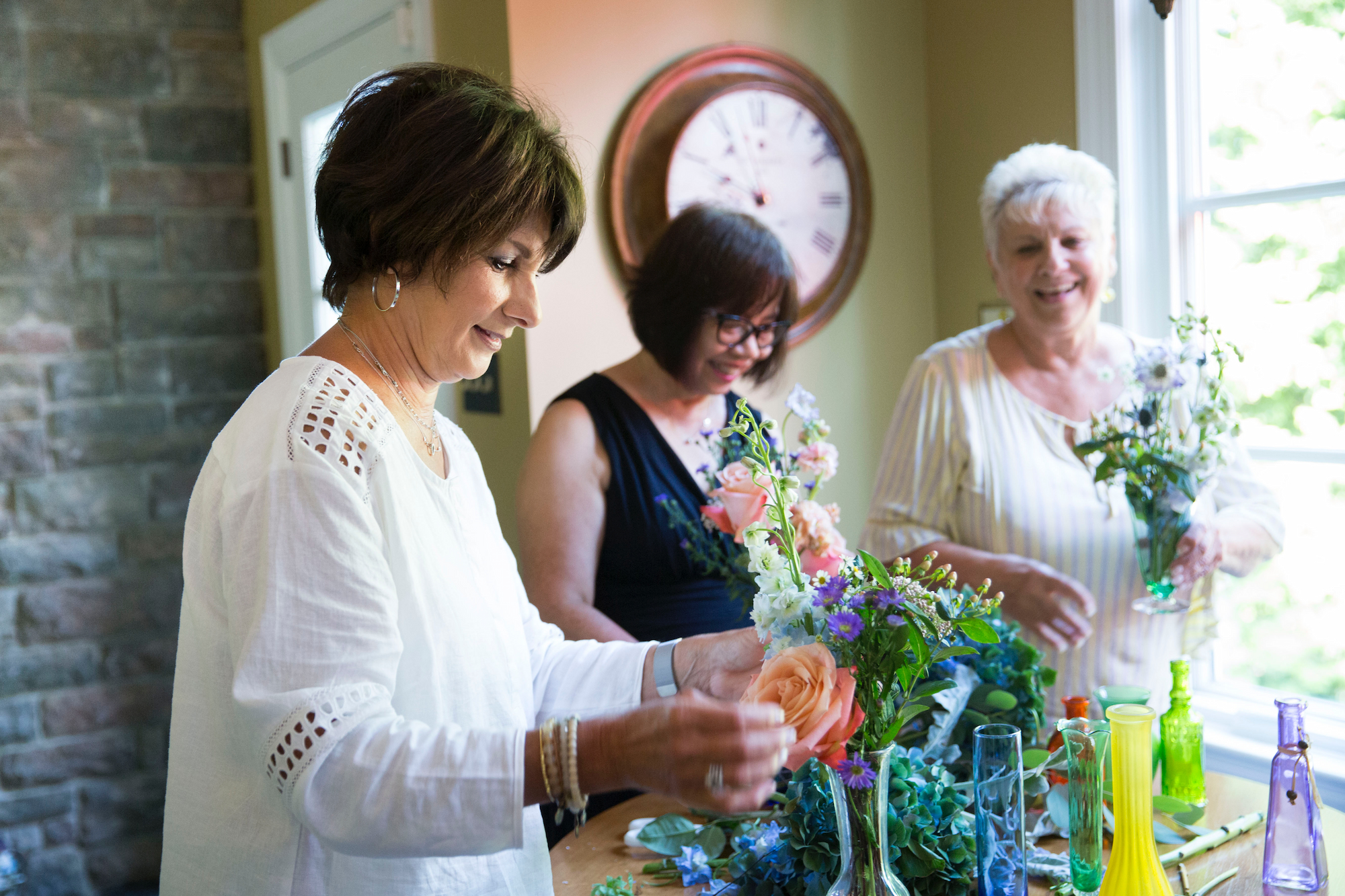 Leona Davis, owner of Forget Me Knot, rearranges wedding flowers into bedside bouquets for the lonely or ill with volunteers in her how.