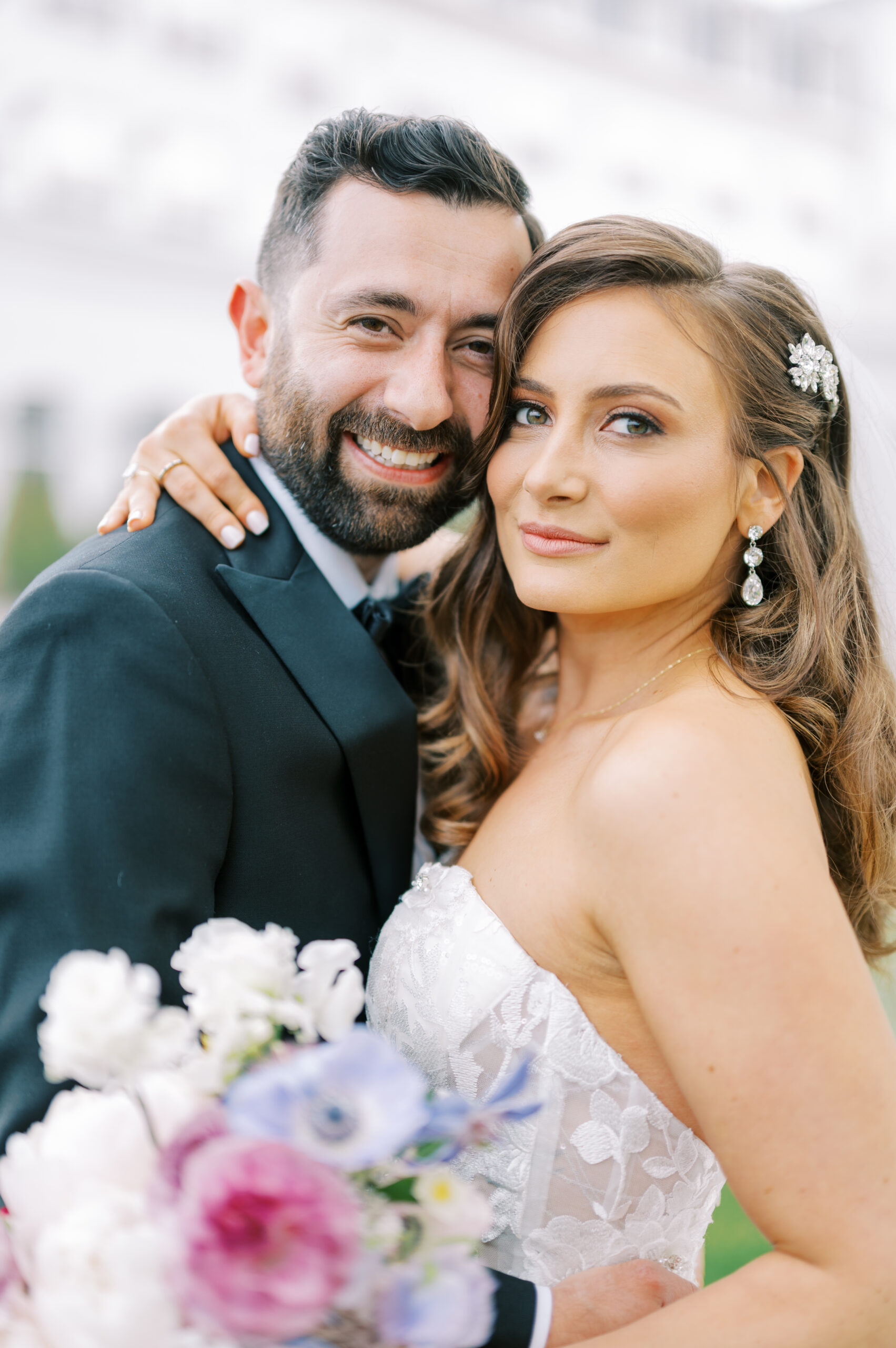 The bride and groom embrace at their Chateau Grande Hotel wedding.