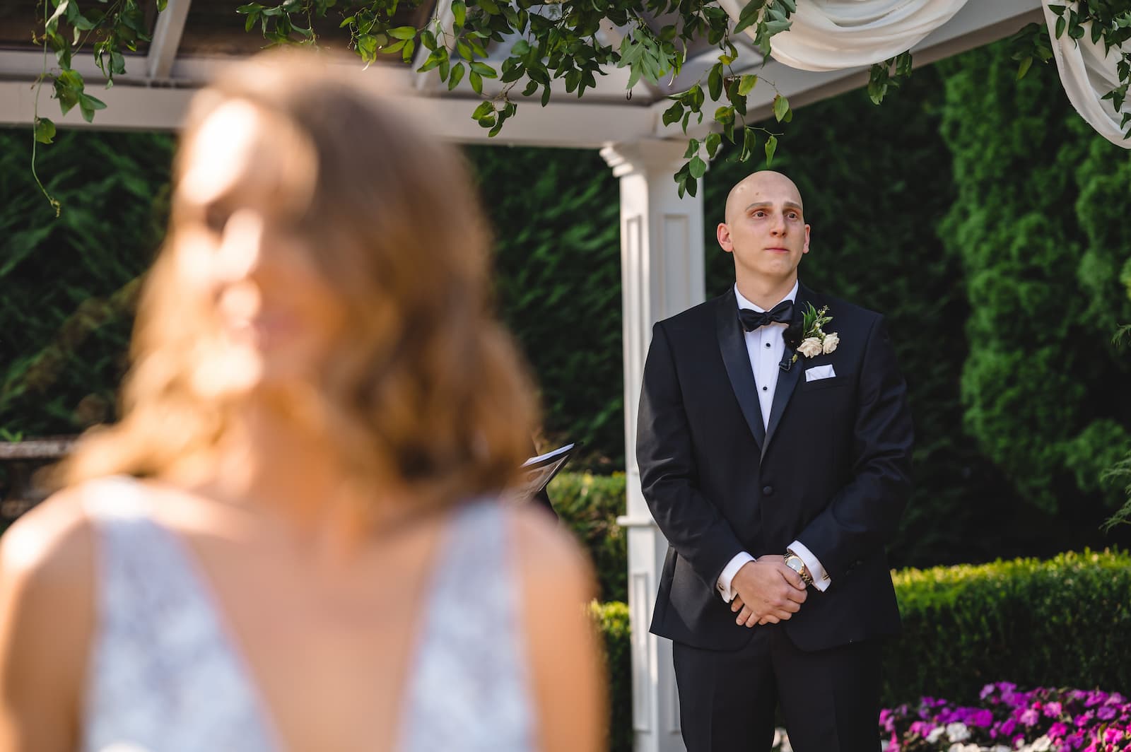 The groom gets emotional at the alter as he faces his bride (not pictured) walking down the aisle.