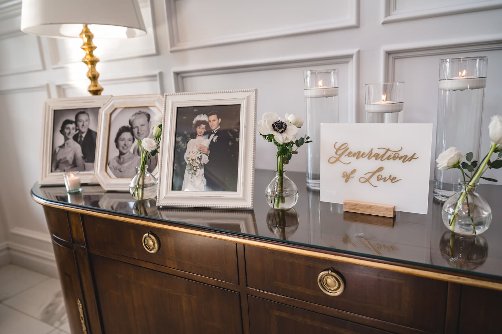 A generation of love table features photos of the bride and groom's grandparents and parents.