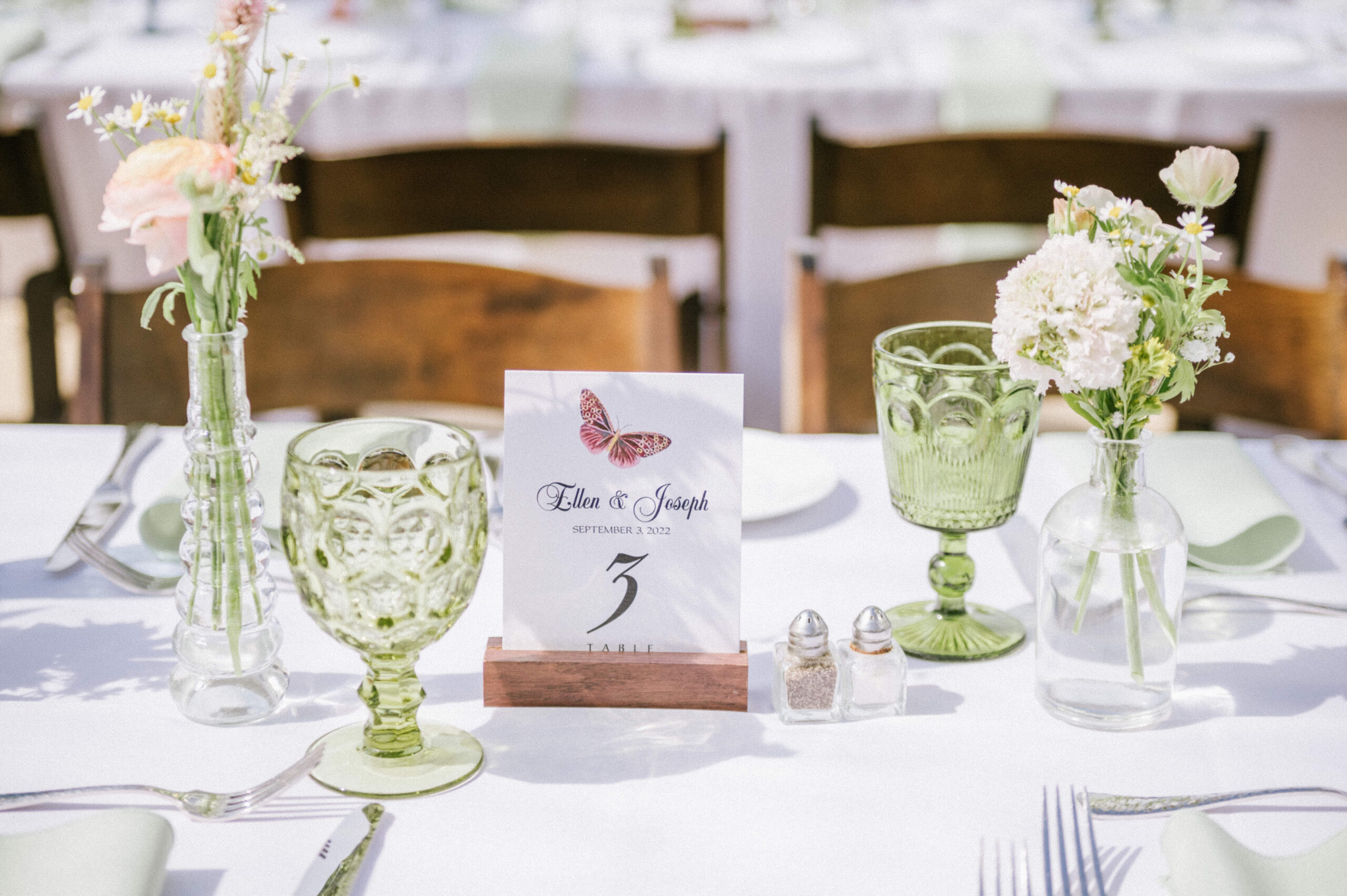 Multi-colored glassware and butterfly-themed table numbers at the Water Witch Club.