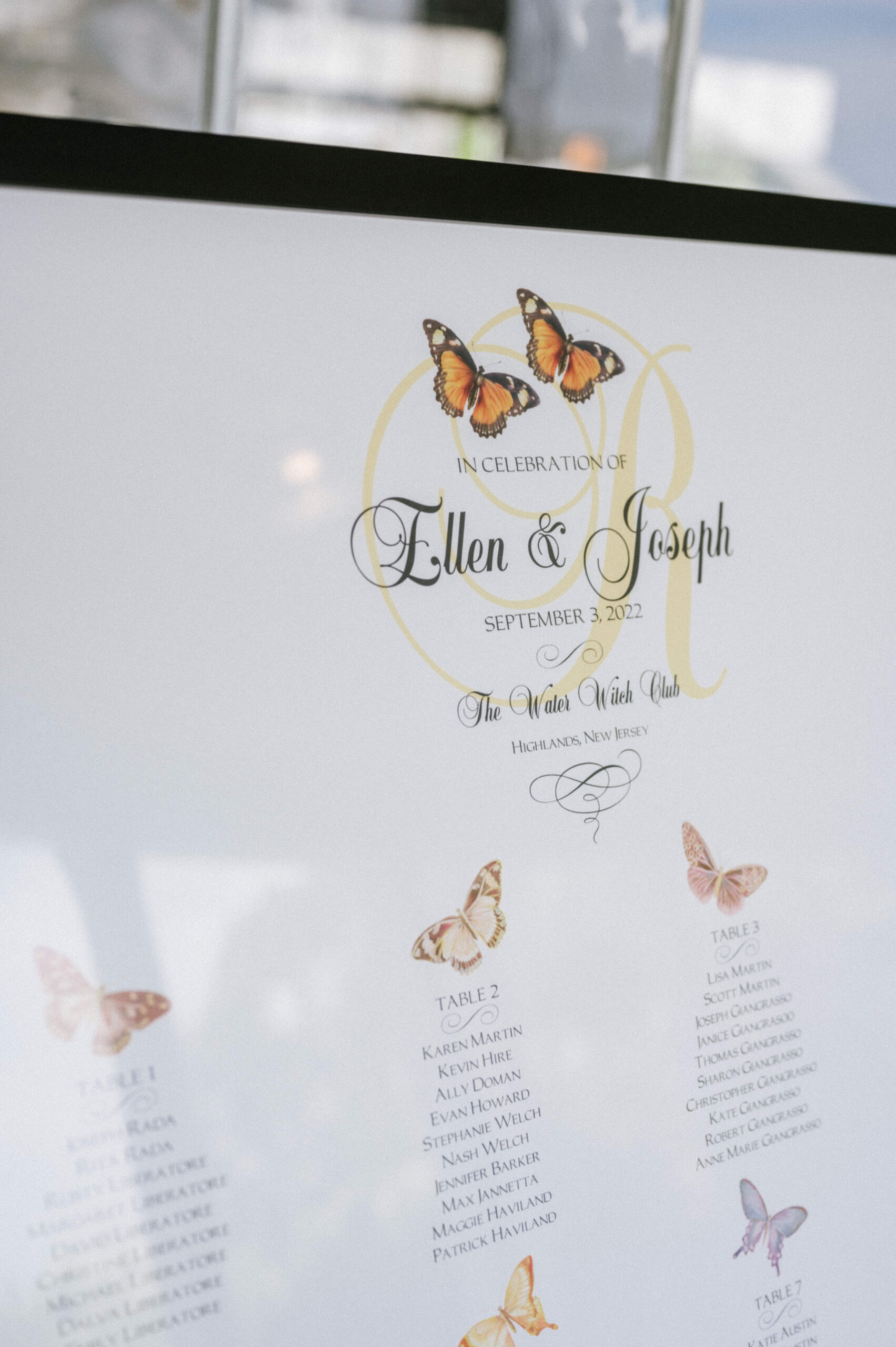 A butterfly themed seating chart at this Water Witch Club wedding.