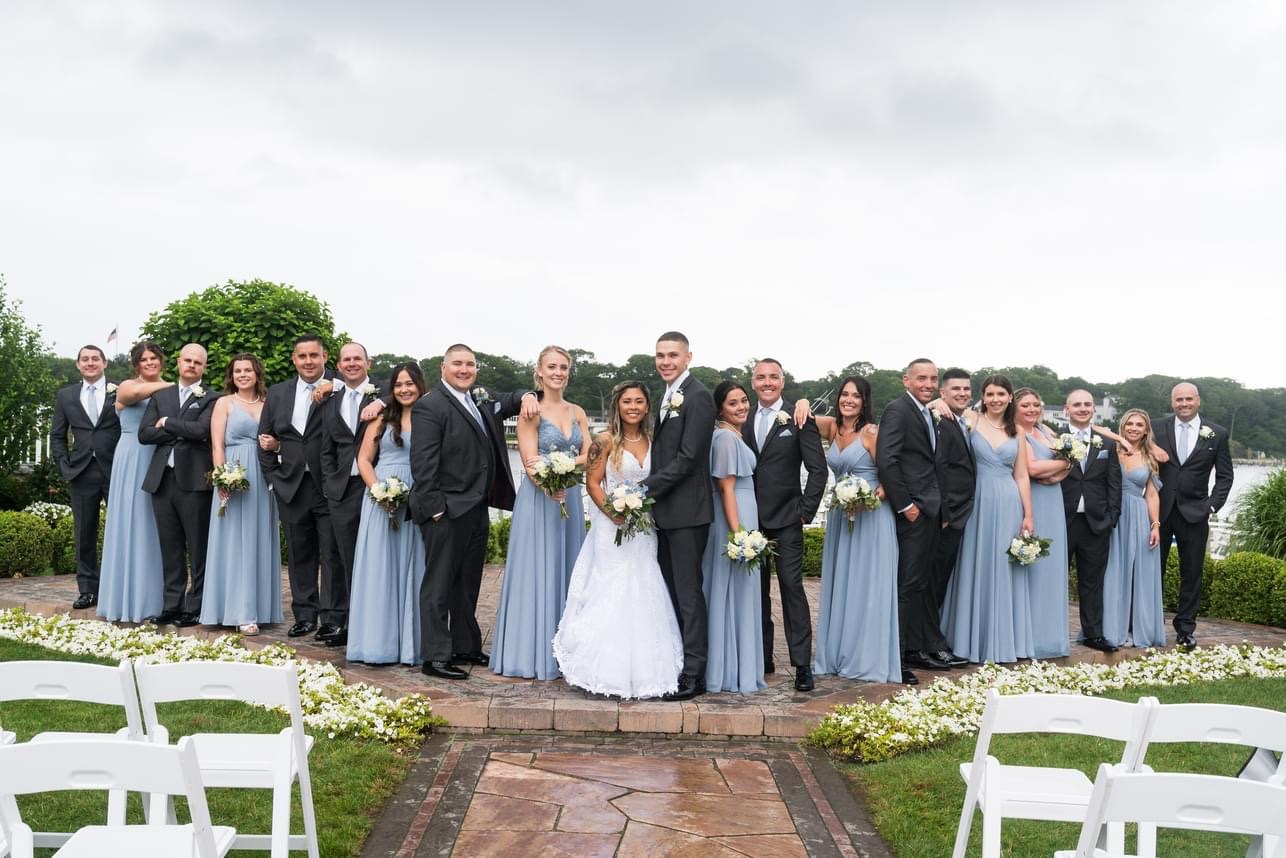 The bride and groom with their wedding party at the Crystal Point Yacht Club.