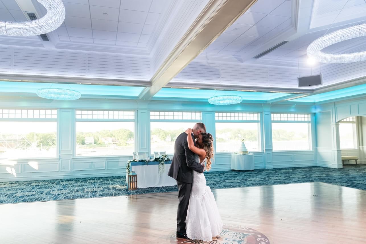 The bride and groom in the ballroom of the Crystal Point Yacht Club.