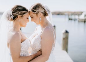 A Waterfront Wedding Featuring The Couple’s Dog & Pride Flags at the Ceremony