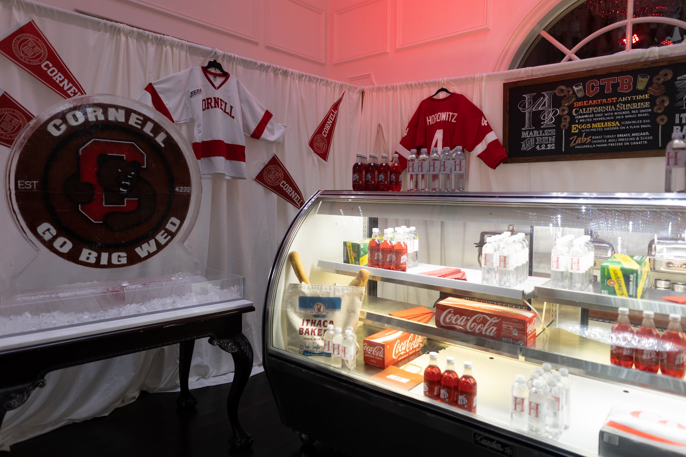 A deli counter with Cornell University apparel on the walls is a shoutout to Collegetown Bagels in Ithaca.