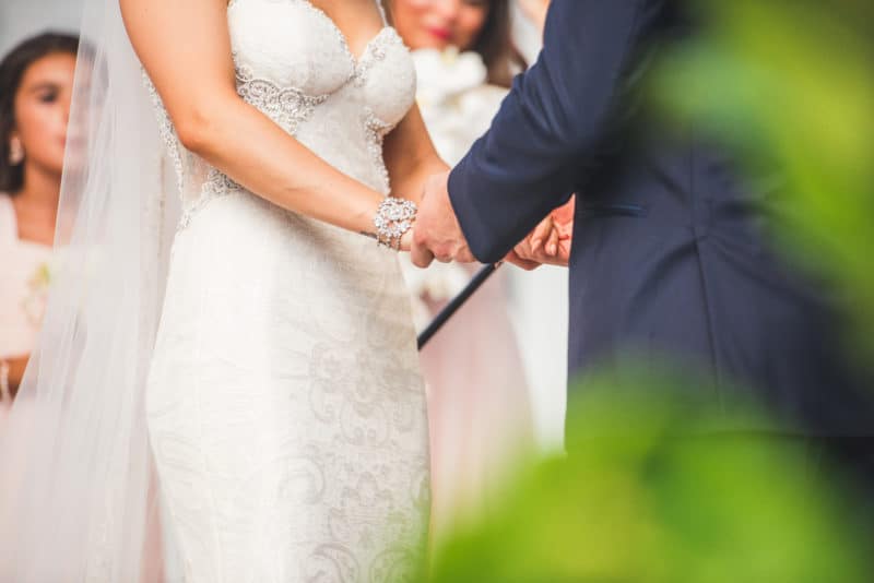 Bride and groom holding hands at the altar at The Ryland Inn
