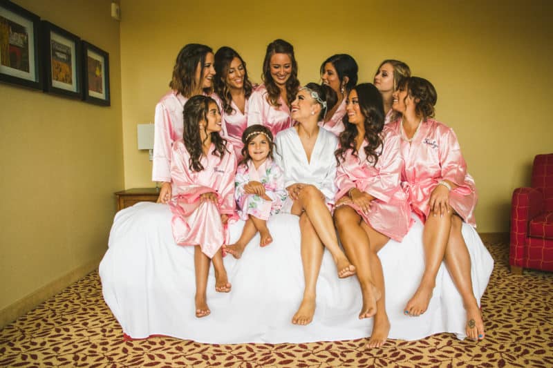 Bride and bridesmaids in matching robes before the wedding 