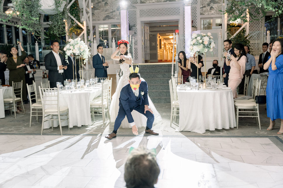 The bride and groom don accessories for their favorite Pokemon characters during their reception at their Madison Hotel wedding.