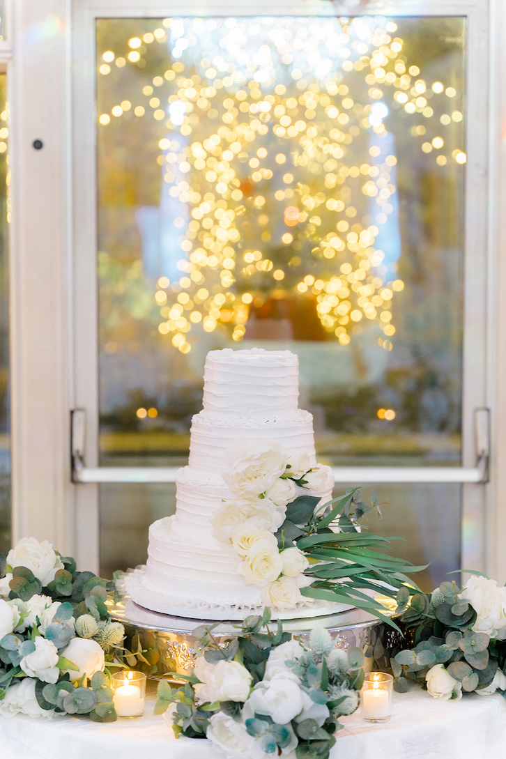 A simple white cake with white flowers and greenery at this Madison Hotel wedding.