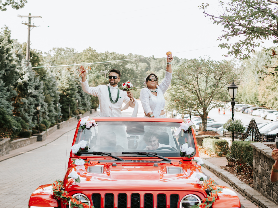 The groom rolls up in a red Jeep for the Baraat at Westmount Country Club.