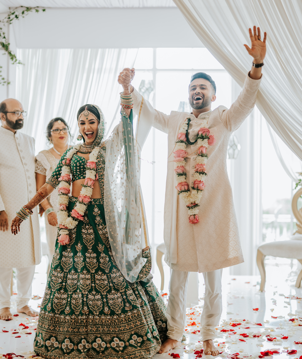 The bride in green and the groom in white at their ceremony at the Westmount Country Club.